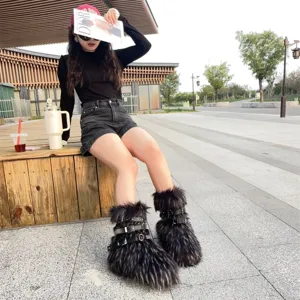 Close-up of Y2K punk style faux fur snow boots with black metal buckle straps