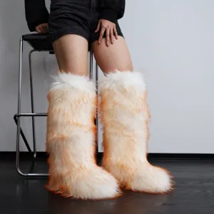 Detailed look at fluffy Y2K faux fur knee-high boots in white and orange on model