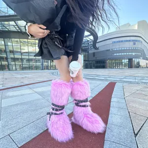 Close-up of pink faux fur punk boots featuring studded black straps and buckle details