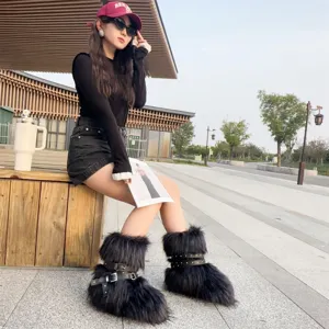 Close-up detail of black faux fur Y2K snow boots with punk style buckles and metal studs