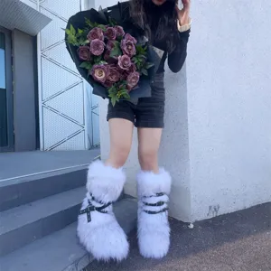 Detailed view of white faux fur Y2K punk snow boots featuring black buckle rivet straps.