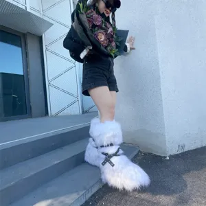 Detailed view of white Y2K style faux fur platform snow boots with punk buckle straps