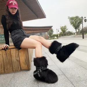 Stylish Y2K punk style black faux fur snow boots with rivet straps and platform soles.