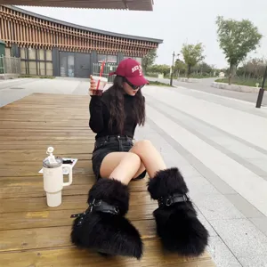 Model wearing black faux fur Y2K punk snow boots with rivet buckle details outdoors