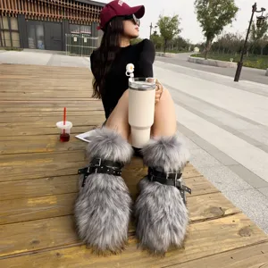 Macro detail view of grey faux fur Y2K punk snow boots with black rivet leather straps