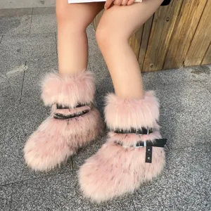 Detailed view of pink Y2K faux fur boots featuring black punk straps and rivets