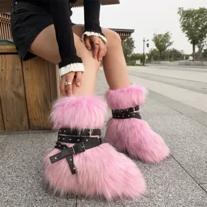 Close-up detail of pink faux fur boots featuring black leather straps and punk silver rivets.