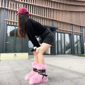 Detailed view of pink faux fur snow boots featuring Y2K punk rivet straps and buckles