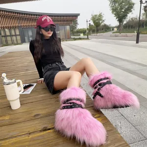 Close-up of pink faux fur platform boots with Y2K punk style studs and black straps