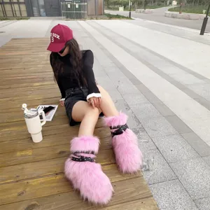 Detail view of pink Y2K faux fur platform boots with black studded buckle straps.