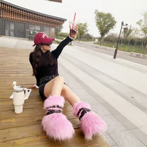 Stylish close-up of pink faux fur Y2K punk platform snow boots with black studded straps