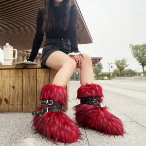 Red faux fur Y2K punk boots featuring black studded straps and metal buckles detail