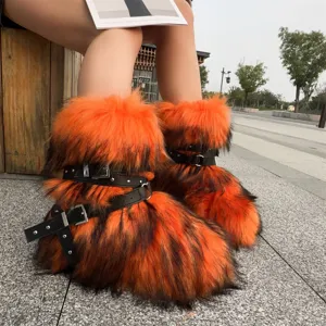 Detail view of Y2K punk style orange faux fur snow boots with black buckle straps