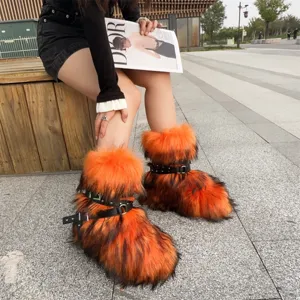 Detail view of orange and black shaggy faux fur Y2K punk boots with rivet straps and thick soles.