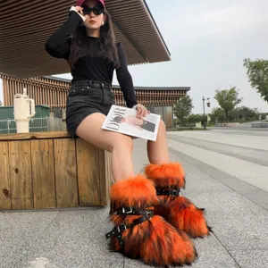 Punk Y2K style orange and black faux fur snow boots with rivet straps for women