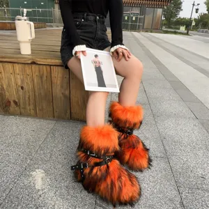 Y2K punk orange and black faux fur snow boots worn by model outdoors