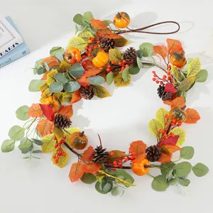 Detailed view of autumn artificial pumpkin pinecone maple leaf wreath for Thanksgiving decoration.