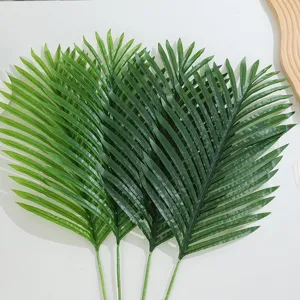 Detailed view of artificial palm leaves showing realistic green texture and stem structure.