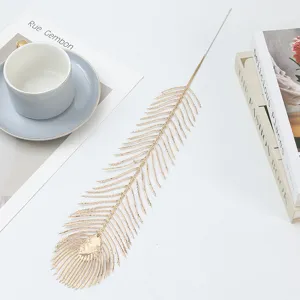 Gold artificial peacock feather leaf stems for home decor, floral arrangement and festivals.