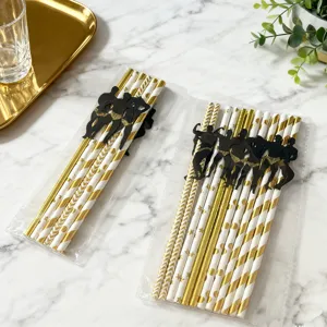 Gold and white paper drinking straws with funny muscle man cutout decorations for party.