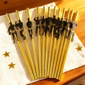 Detail view of creative gold paper drinking straws featuring muscular bodybuilder cutouts for party.