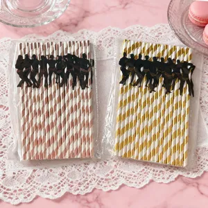 Bachelorette party paper straws with muscular man silhouette decorations, stylish striped design.
