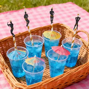 Creative bachelorette party paper straws with muscular man cutout and colorful umbrellas for drinks