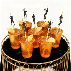 Creative muscle man paper straws for bachelorette party, gold cups with orange drink display.