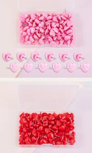 Pink and red heart-shaped push pins with clear storage box for cork board photo wall.