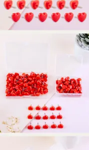 Red heart-shaped pushpins with clear storage boxes, ideal for cork boards and photo walls.