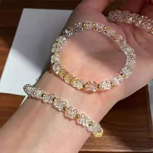 Crystal beaded bracelet with gold spacers, detailed view of sparkling faceted crystals.