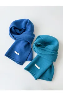 Close-up detail of cozy wool winter scarf, soft knitted texture and warm accessory design.