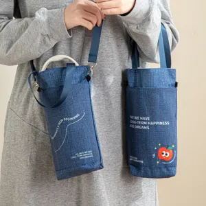 Portable denim water bottle bag with cute apple print and strap, stylish reusable cup sleeve for daily use.