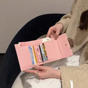 Pink women long tri-fold wallet with multiple card slots and snap closure for daily use.
