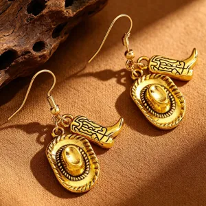 Detailed close-up of vintage gold Western cowboy hat and boot charm earrings.