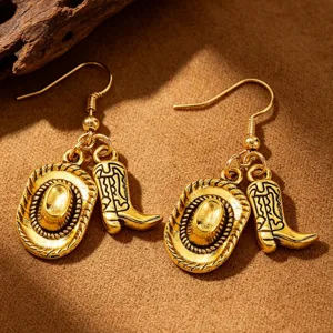Close-up view of vintage gold western cowboy hat and boot charm drop earrings for women
