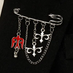 Detailed view of silver ethnic brooch with red Kazakh eagle charm on black fabric