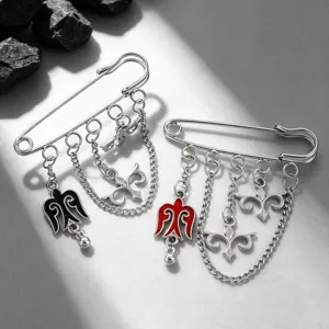 Detailed view of Kazakh ethnic brooches with silver chains and colorful enamel charms.