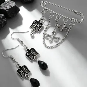 Close-up detail of ethnic Kazakh-style silver brooch with chains and black drop earrings
