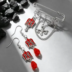 Detail of Kazakh style brooch and earrings set with red enamel charms and beads