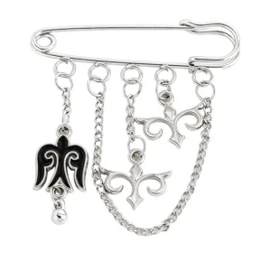 Close-up detail of a silver Kazakh ethnic style safety pin brooch with black enamel charms