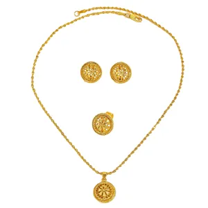 Close-up view of vintage hollowed-out gold jewelry set including necklace and earrings