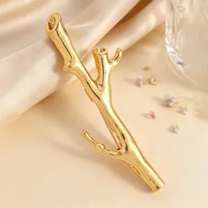 Detailed close-up of a gold tree branch brooch with unique DIY flower insertion feature