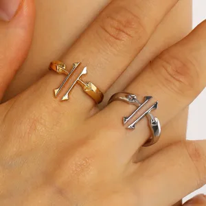 Close-up macro detail of minimalist gold and silver double cross open rings for women