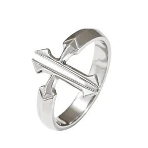 Close-up of a silver minimalist double cross open ring with polished finish