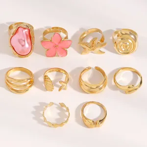 10pcs vintage gold ring set featuring pink baroque pearl, flower, starfish, and shell designs.
