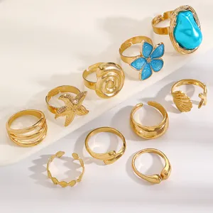 Close-up of 10pcs gold vintage ring set featuring baroque pearls and ocean motifs