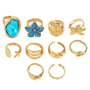 Detailed view of vintage gold ring set featuring baroque shell and flower designs