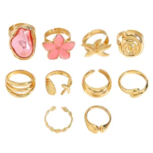 Detailed view of 10pcs vintage gold ring set with baroque pearl and starfish motifs.