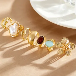 Detailed close-up of gold vintage ring set with baroque pearl and flower motifs